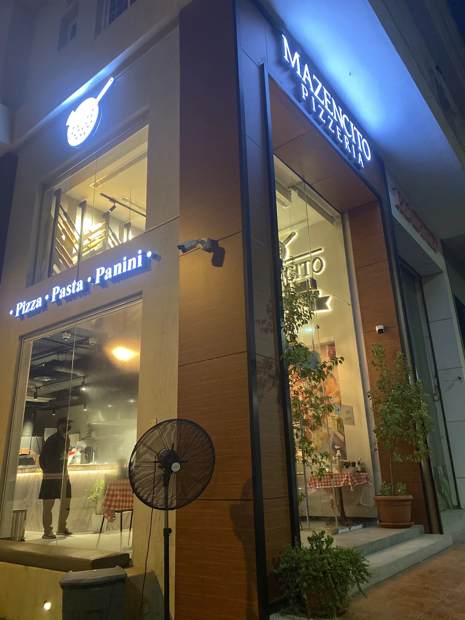 Mazencito Pizzeria shopfront entrance at night