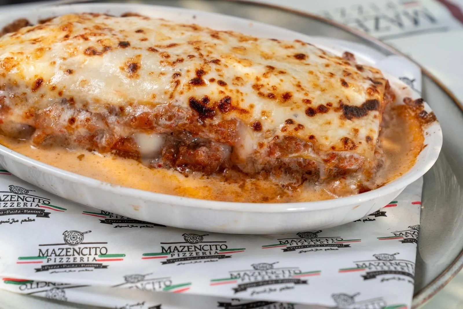 Lasagna della Casa with bubbling béchamel at Mazencito Pizzeria