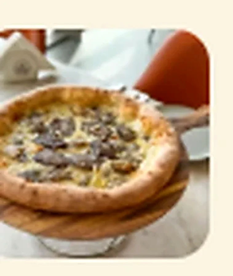 Wagyu Truffle pizza with Parmesan and fresh truffle slices
